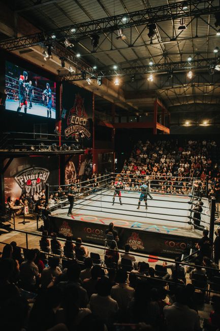 Boxkampf im Ring vor vollem Publikum bei einem Wettkampf
